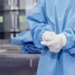 A doctor is wearing gloves