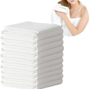 Stack of white towels with a woman holding one.