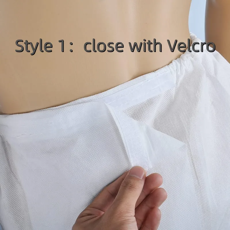 Hand fastening Velcro on white garment.