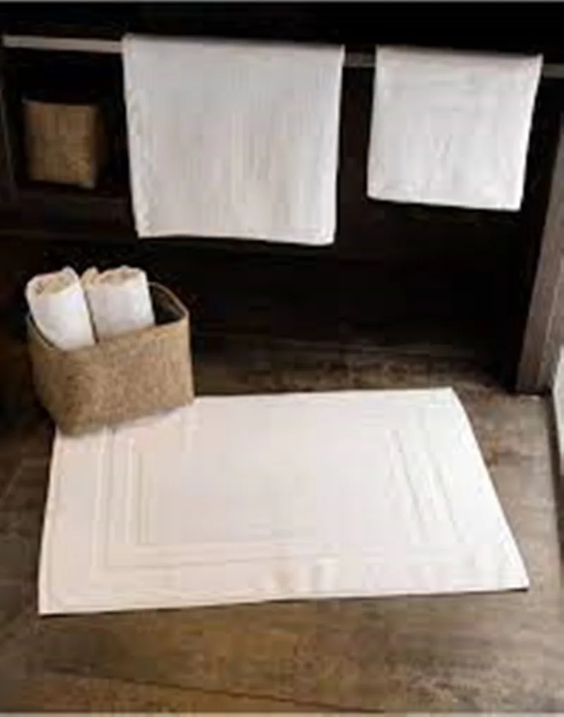 Bathroom towels and rug on wooden floor