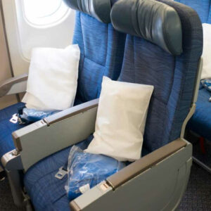 Airplane seats with pillows and blankets.