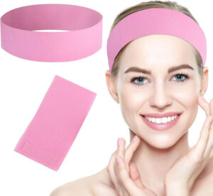 Woman wearing pink exercise headband and towel
