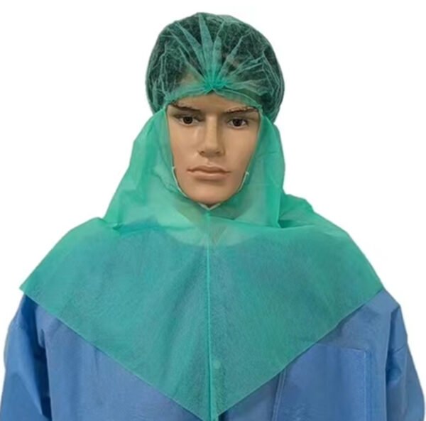 Mannequin wearing green medical surgical cap and gown.