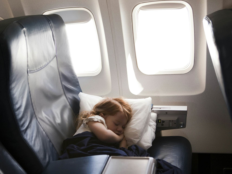 Child sleeping on airplane seat