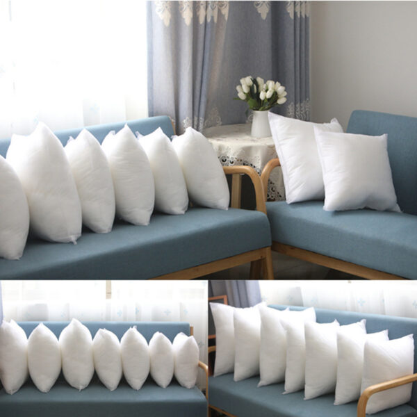 White pillows on blue chairs in living room.