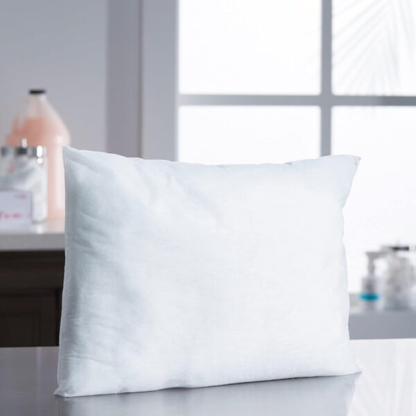 White pillow on reflective surface