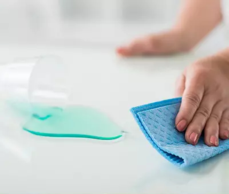 Cleaning spilled liquid with blue cloth