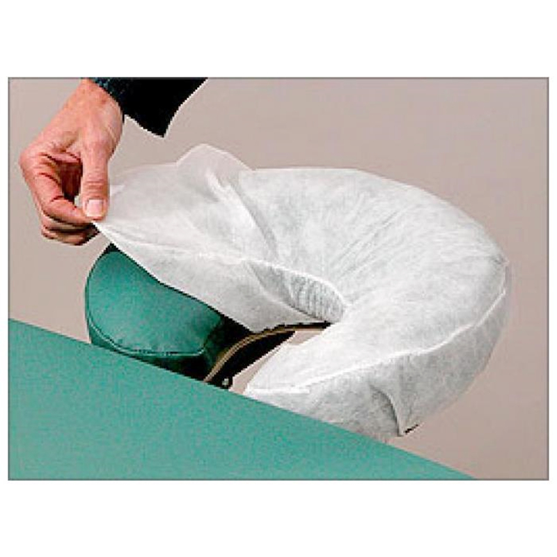 Person putting cover on massage table headrest