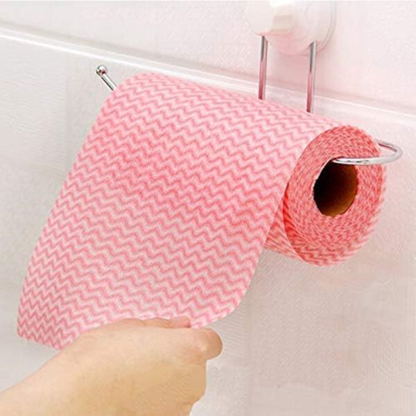 Person pulling pink paper towel from wall holder.