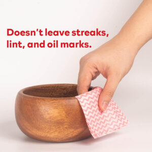 Hand cleaning wooden bowl with cloth, no streaks.