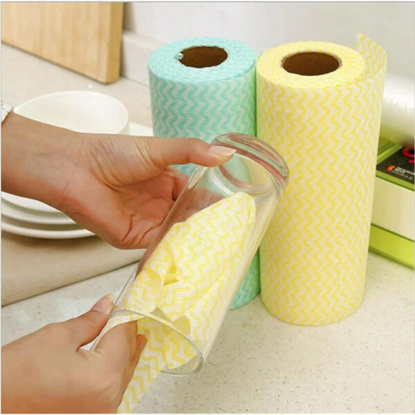 Colorful kitchen towels stored in a glass container.