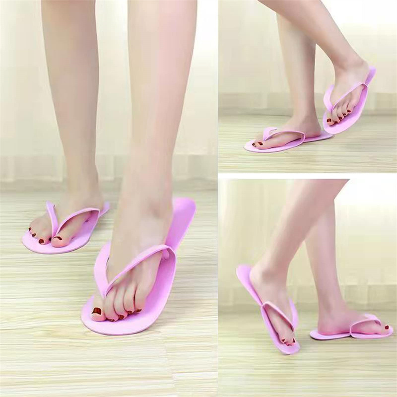 Person wearing pink disposable flip-flops