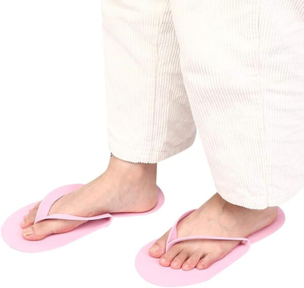 Person wearing white pants with pink slippers.