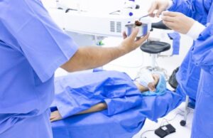 Surgeons preparing for eye surgery in operating room.