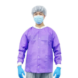 Person wearing purple scrubs and protective gear